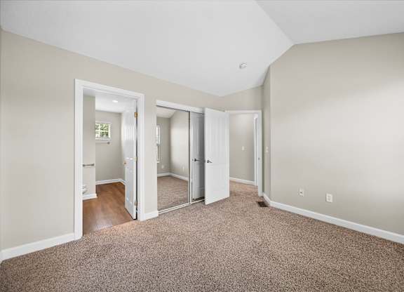 A room with carpeted floor and white walls.