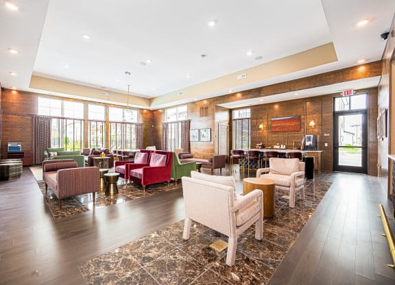 a lobby of a hotel with couches and chairs and a bar