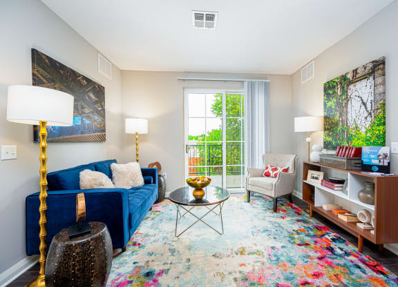 a living room with a blue couch and a window