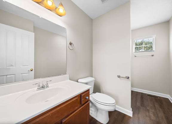 A white sink and toilet in a bathroom.