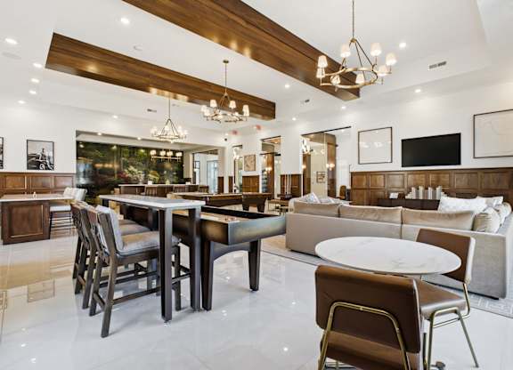A modern dining room with a wooden table and chairs.
