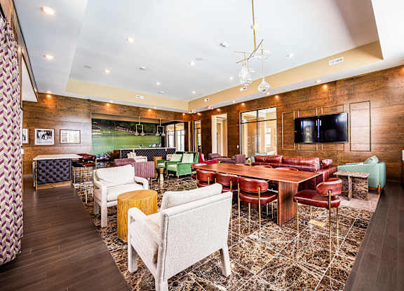 A room with a long table surrounded by chairs.