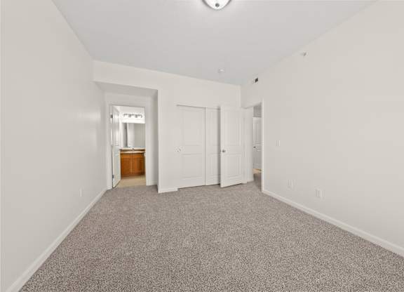 A room with a carpeted floor and white walls.