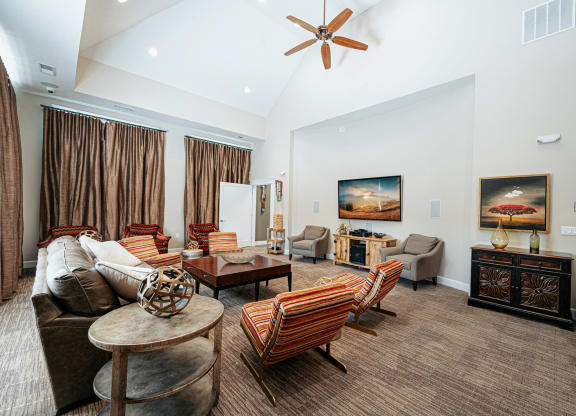 a living room with furniture and a ceiling fan