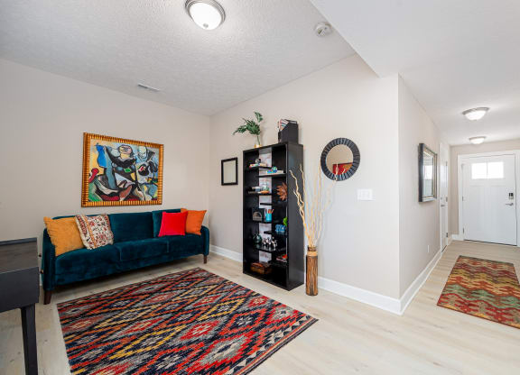 a living room with a couch and a door to a hallway