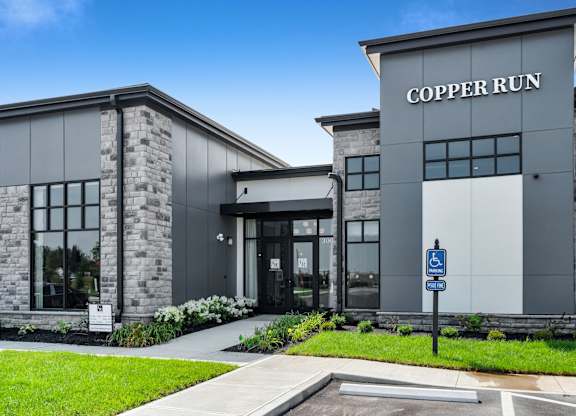 The front of a building with the name "COPPER RUN" on it.