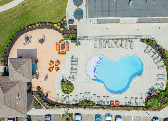 an aerial view of a swimming pool in a parking lot