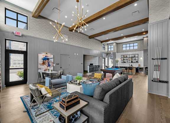 A modern living room with a grey sofa and a wooden coffee table.