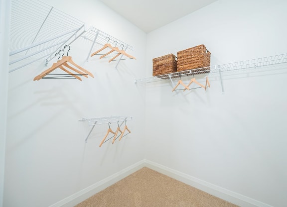 a closet with shelves and baskets on the wall