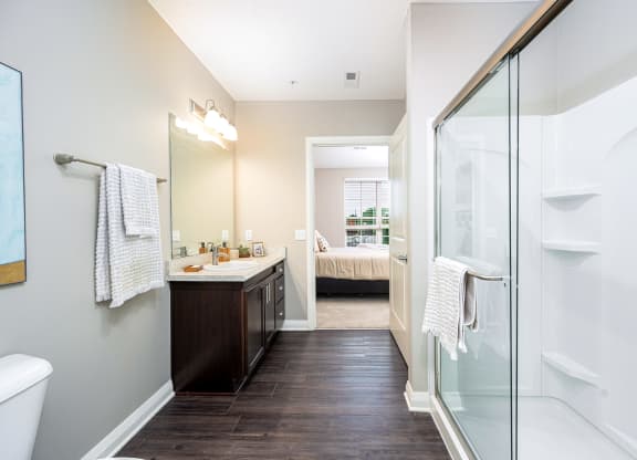a bathroom with a glass shower and a sink