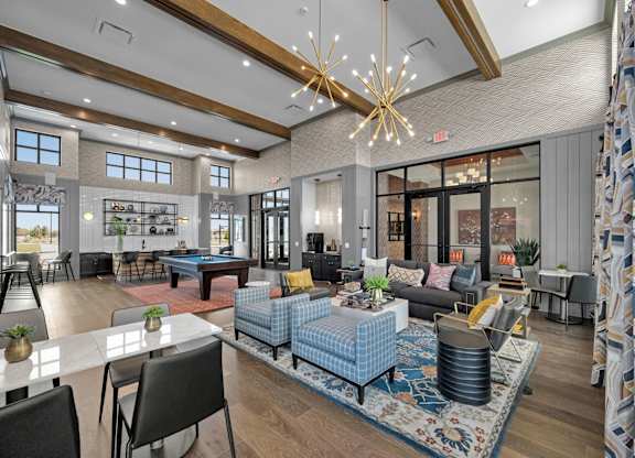 A modern living room with a pool table and a dining table.