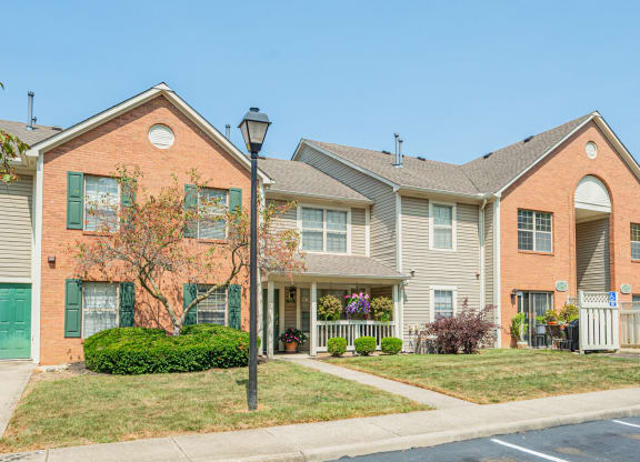 a row of houses with a sidewalk in front of them
