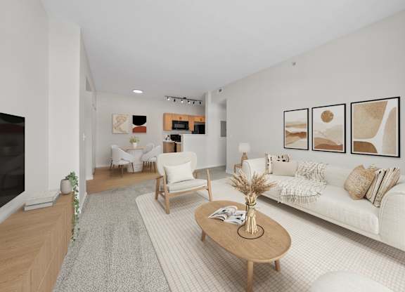 A living room with a white couch, a coffee table, and a fireplace.