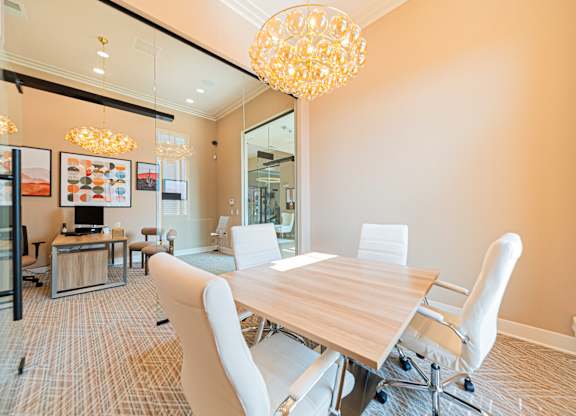 A conference room with a long table and chairs.