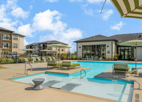our apartments offer a swimming pool with chairs and umbrellas