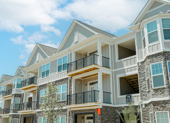 a row of homes with balconies on a sunny day