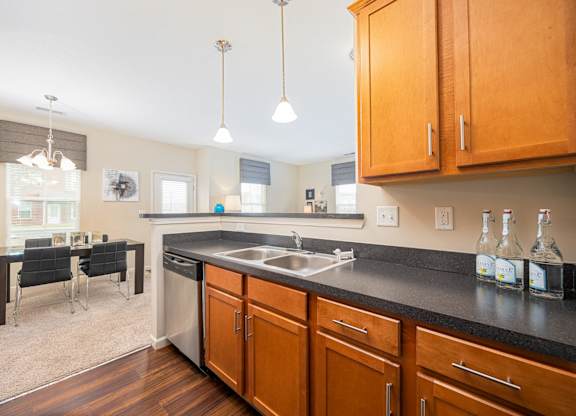 A kitchen with wooden cabinets and a black countertop.