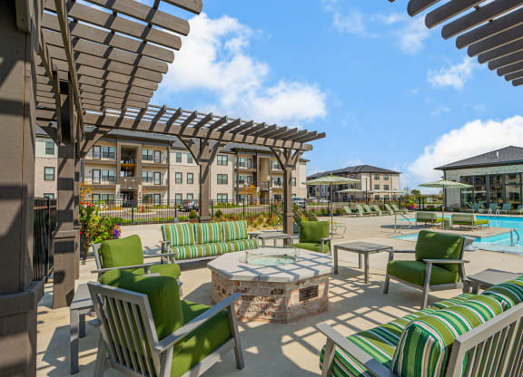 our apartments have a large patio with furniture and a pool
