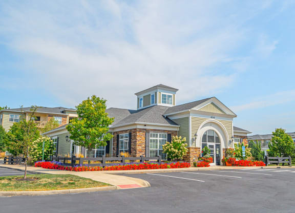an exterior view of a building with a parking lot