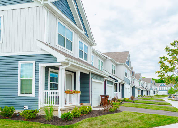 a row of houses with blue and white siding