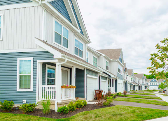 a row of houses with blue and white siding
