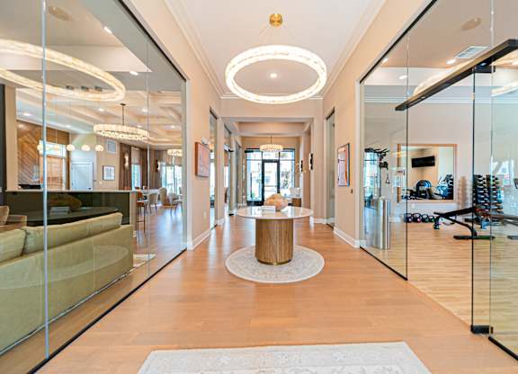A spacious living room with a large mirror on the wall.