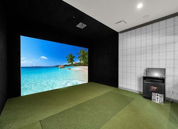 A room with a large screen and a projector.