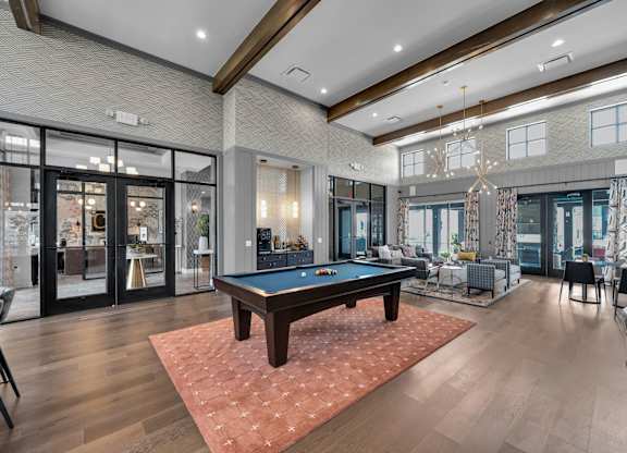 A large room with a pool table and a billiard table.