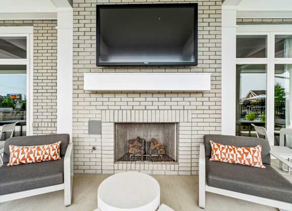 A white fireplace with a flat screen TV above it.