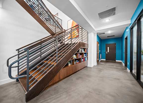 A staircase with a metal railing and wooden steps.