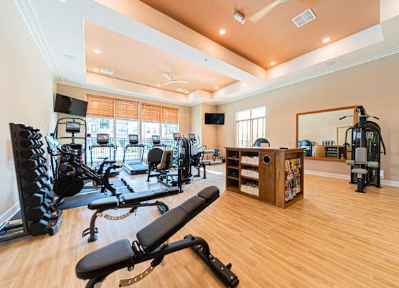 A spacious home gym with a variety of equipment.