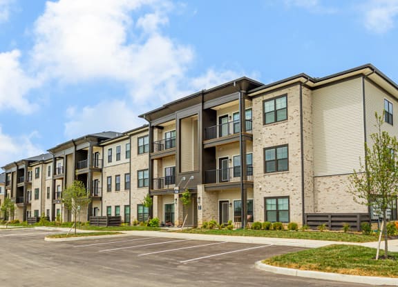 a parking lot in front of an apartment building