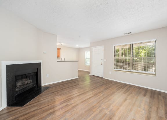 a living room with a fireplace and a window