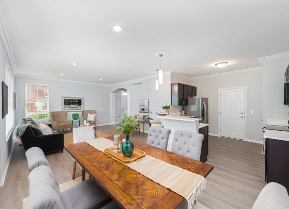 a living room and dining room with a wooden table