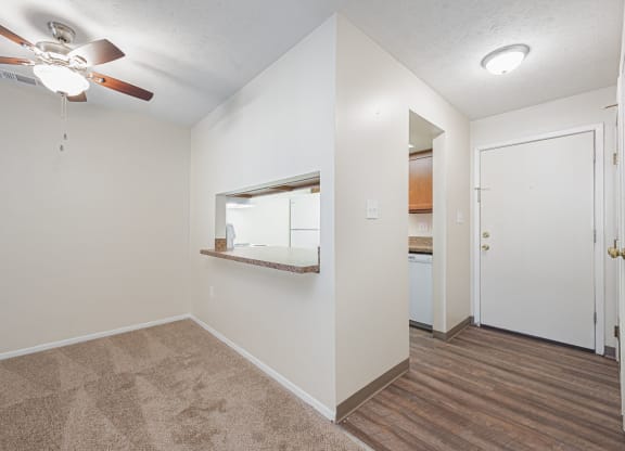 a bedroom with a ceiling fan and a door to a bathroom