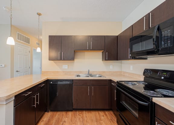 a kitchen with black appliances and a counter top