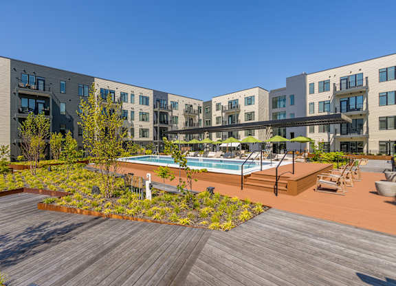A modern building with a pool in the courtyard.