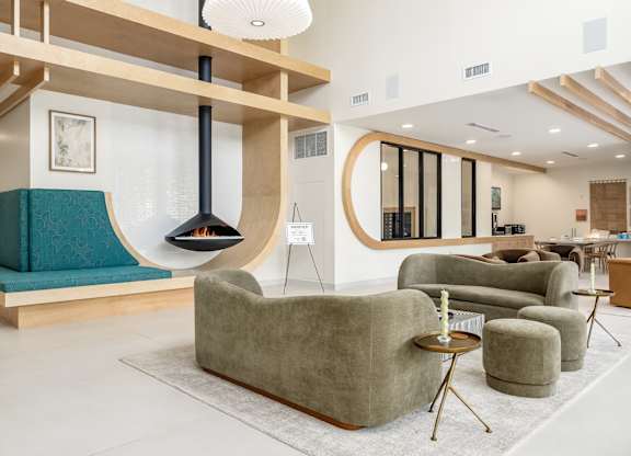 A modern living room with a fireplace and comfortable seating.
