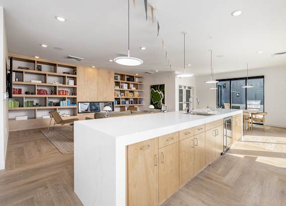 A modern kitchen with wooden cabinets and a white island.