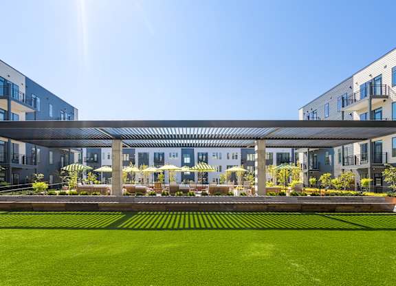 A modern building with a green lawn in front.