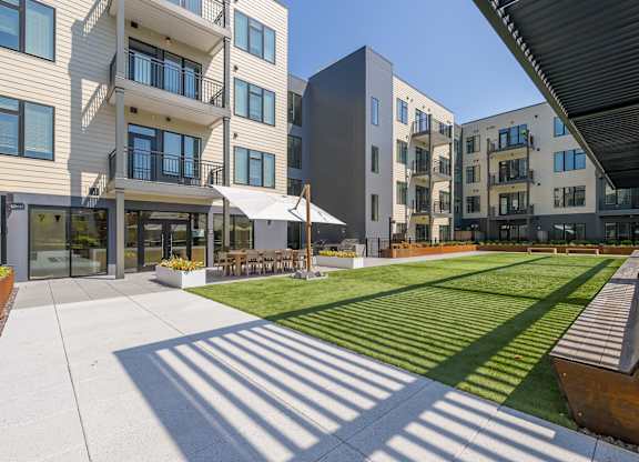 A modern building with a green lawn in front.