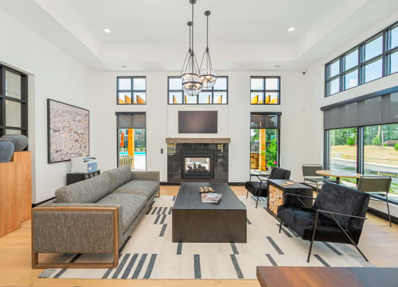 a living room with a couch and a coffee table and a fireplace