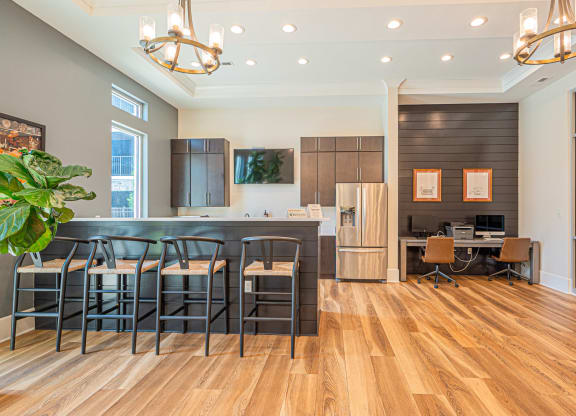 a dining room with a bar and a kitchen with a table and chairs