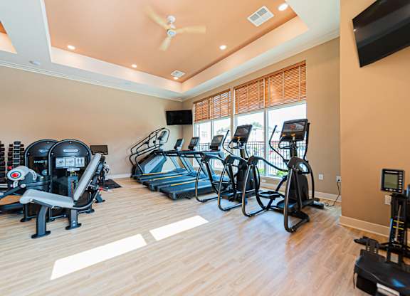 A spacious home gym with a variety of exercise equipment.