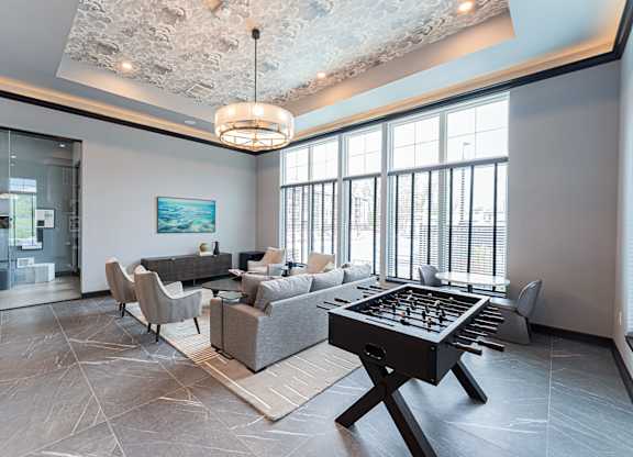 A large room with a pool table in the middle.