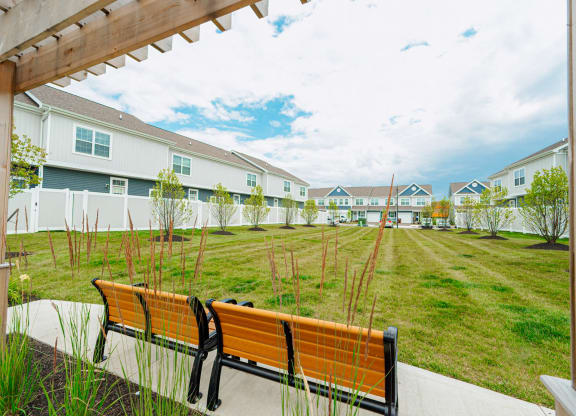 a group of benches in front of some houses