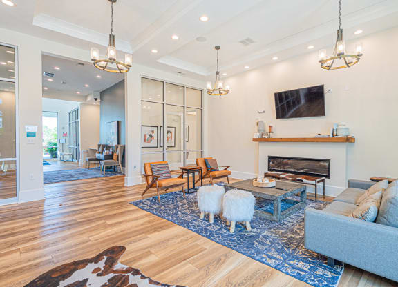 a living room with two sheep in front of a fireplace
