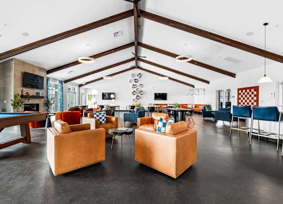 A room with a pool table and a couch.