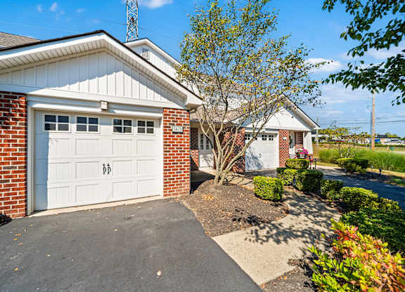 A house with a white garage door is shown in the image.