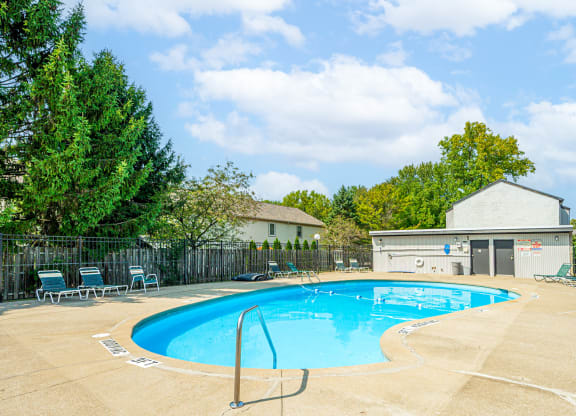 our apartments have a resort style pool with chairs and a fence